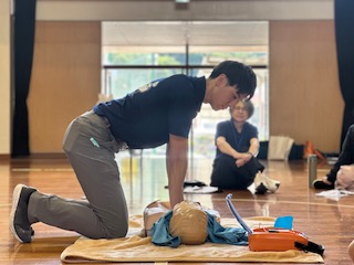 救命講習受講者が胸骨圧迫している写真