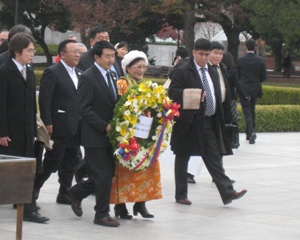 Mongolian speaker offering a flower wreath 