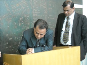 Minister Khan writing a message at the Peace Memorial Museum
