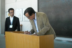 Minister Meena writing a message at the Peace Memorial Museum